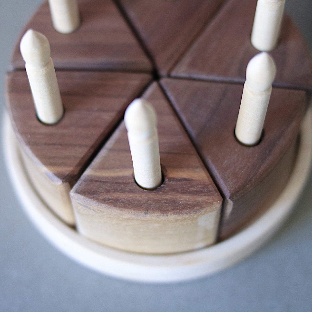 Wooden puzzle with interlocking pieces on a gray background
