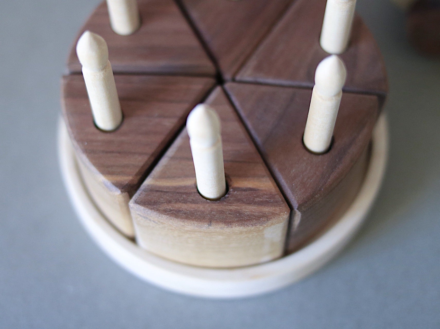 Wooden puzzle with interlocking pieces on a gray background